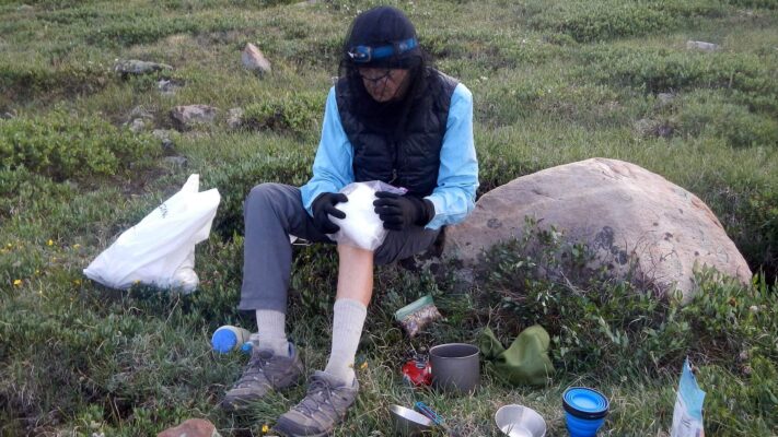 High Uintas Wilderness, snow makes good ice pack for hurt knee, July2021